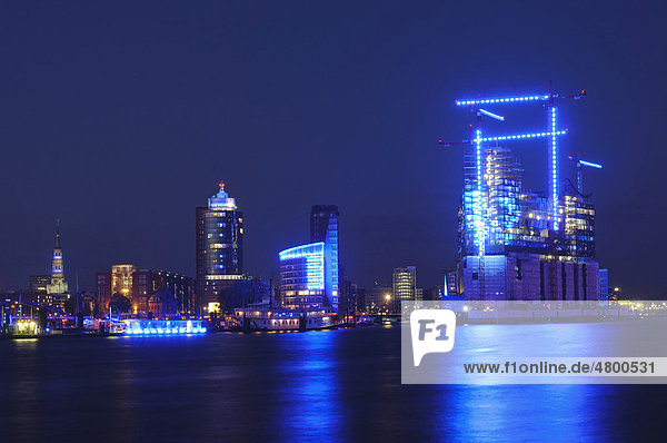 Blue illuminated buildings at the Kehrwiederspitze in the port of Hamburg at the Cruise Days 2010  Blue Port art project by the artist Michael Batz  Elbphilharmonie philharmonic hall  HTC Hanseatic Trade Center  Hafencity district  Hamburg  Germany  Europe