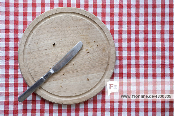 Empty breakfast plate with a knife  top view