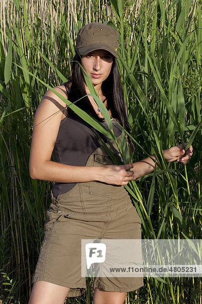 Young woman standing amongst the reeds