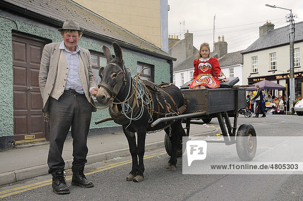 Old farmer and child wearing modern Celtic costume  girl sitting on a traditional donkey cart outside the Sinn FÈin Party offices  Irish Republican Party  Birr  Offaly  Midlands  Ireland  Europe
