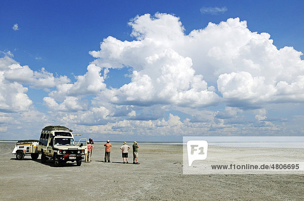 Off-road vehicle with tourists on a salt lake in Nata Bird Sanctuary  Makgadikgadi Pans  Botswana  Africa