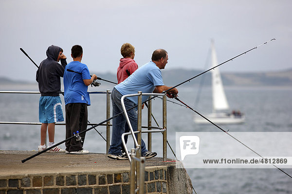 Anglers on the pier of Castle Cornet  fortress in the harbor entrance of St. Peter Port  Guernsey  Channel Islands  Europe