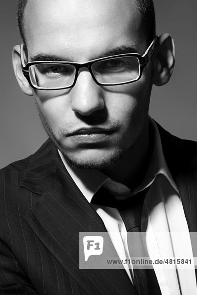 Portrait of a young man with glasses  suit  shirt and tie