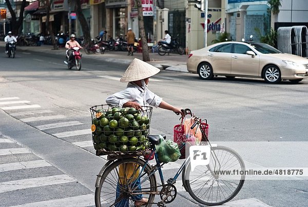 Lady selling Oranges from her Bike Saigon  Vietnam
