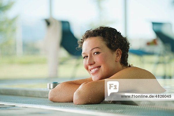 Italy  South Tyrol  Woman in swimming pool of hotel urthaler  smiling