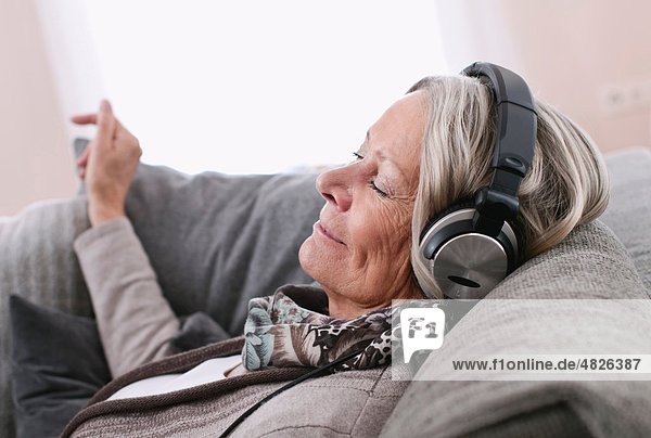 Senior woman listening music