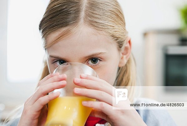 Girl drinking orange juice  portrait