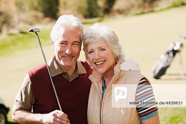 Italien  Kastelruth  Erwachsenes Paar im Golfwagen auf dem Golfplatz  lächelnd  Portrait