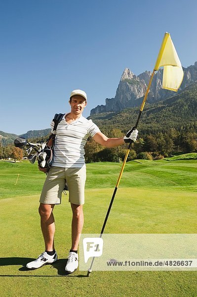 Italy  Kastelruth  Mid adult man on golf course  portrait