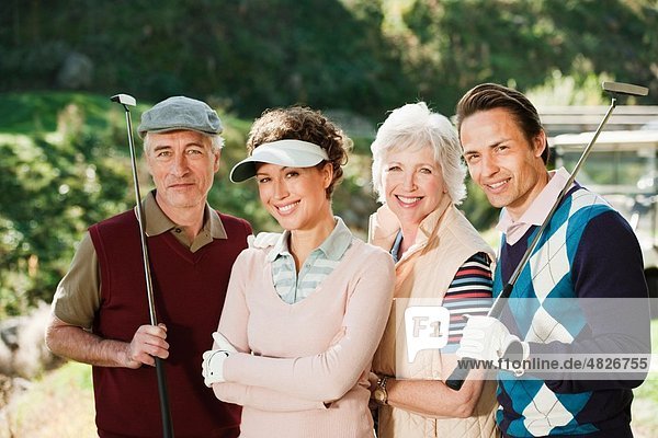 Italy  Kastelruth  Golfers on golf course  smiling  portrait