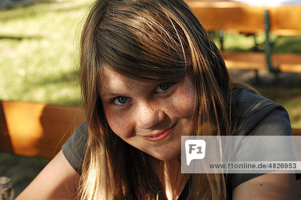 Girl  10  with freckles  looking directly at the camera