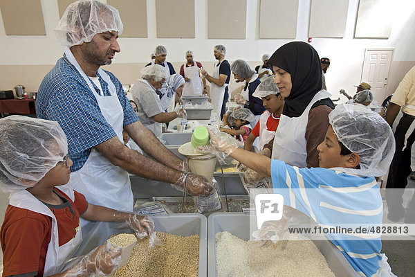Volunteers working through the Islamic Relief charity prepare meal packages for Detroit area families in need which will be distributed through local soup kitchens and worldwide by Kids Against Hunger  Detroit  Michigan  USA
