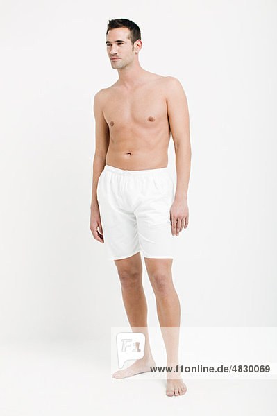 Portrait of young man wearing white boxer shorts