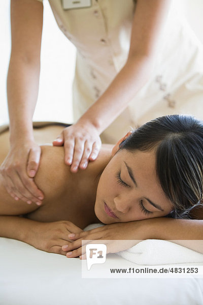 Young woman having shoulder massage