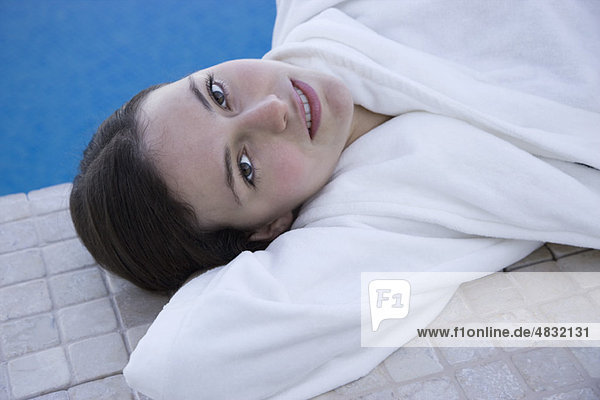 Woman relaxing beside pool  portrait