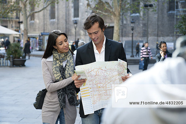 Couple walking outdoors  consulting map