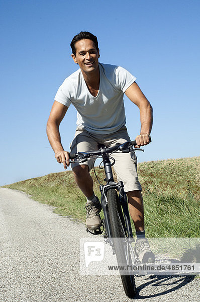 Man cycling on a country road