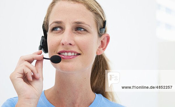 Woman with headset in bright office