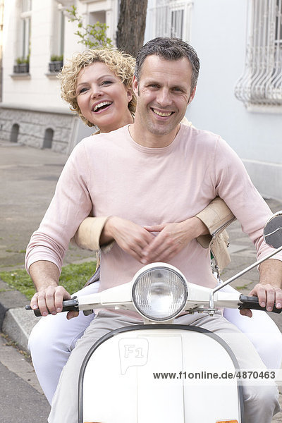 Mature couple on a scooter