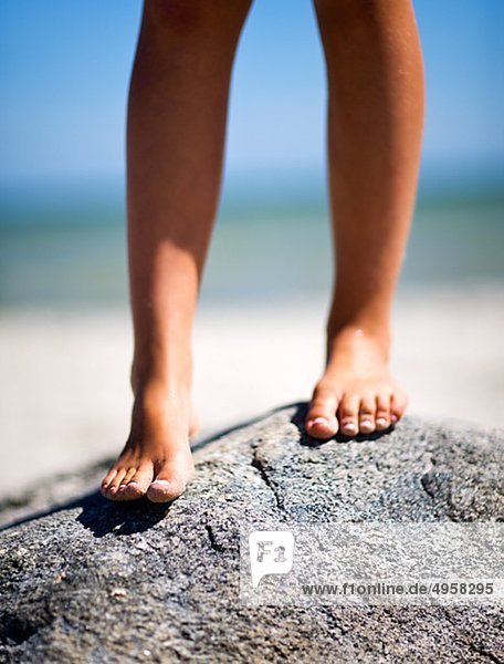 Girls barefoot on stone  close-up