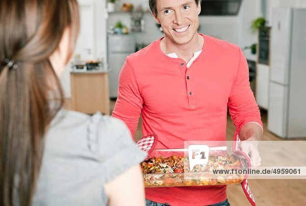 Man holding baking tray