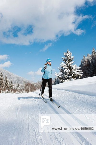 Senior woman doing cross-country skiing