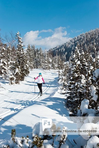 Senior woman doing cross-country skiing