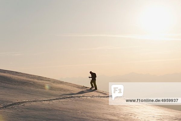 Italy  Trentino-Alto Adige  Alto Adige  Bolzano  Seiser Alm  Mid adult man on ski tour in morning