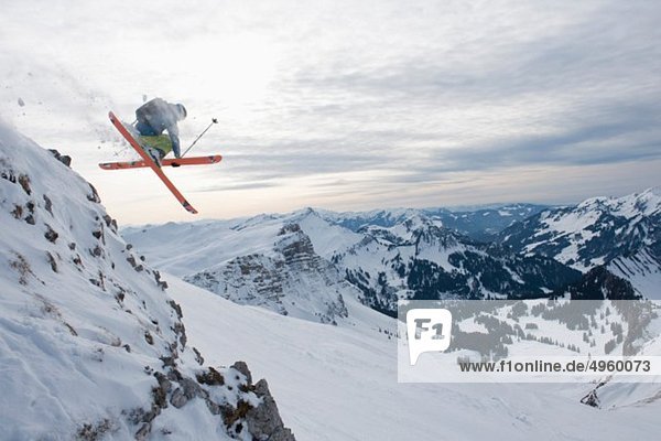 Austria  Kleinwalsertal  Male skier jumping mid-air