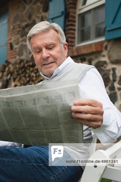Senior man reading newspaper
