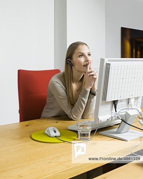 Young woman with pc in office