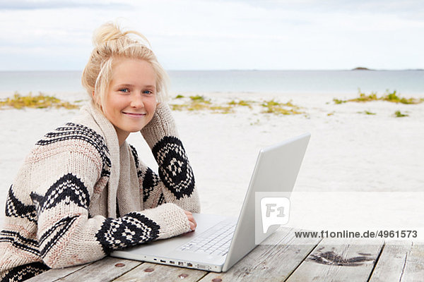 Teenagerin sitzen am Tisch  mit laptop
