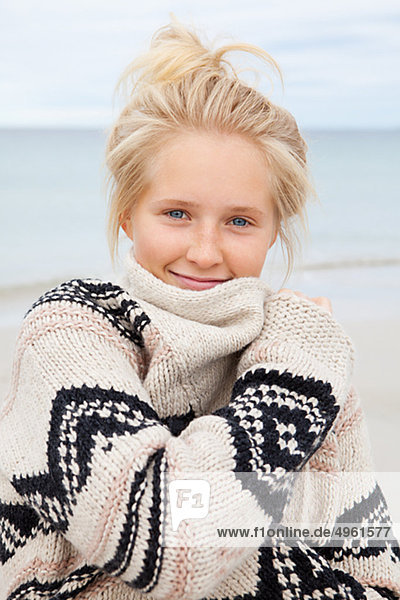 Teenage girl standing on beach  portrait