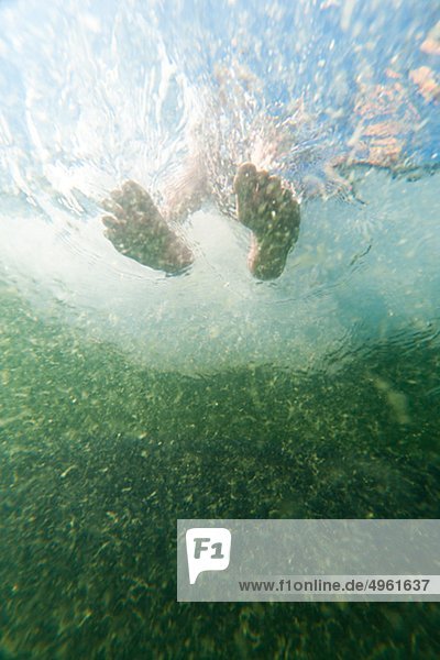 Low angle view of feet in water