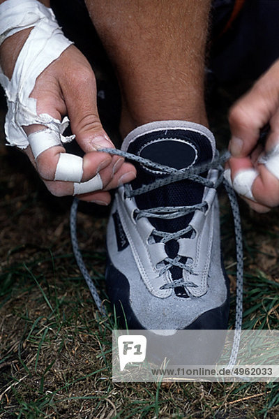 Man tying training shoes
