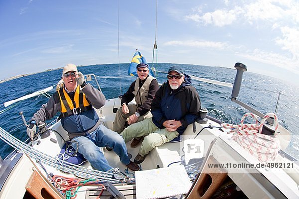 Three men relaxing on sailboat