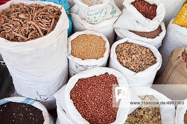 Various beans in sacks in market stall