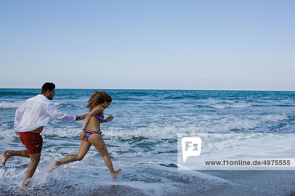 couple running on the beach