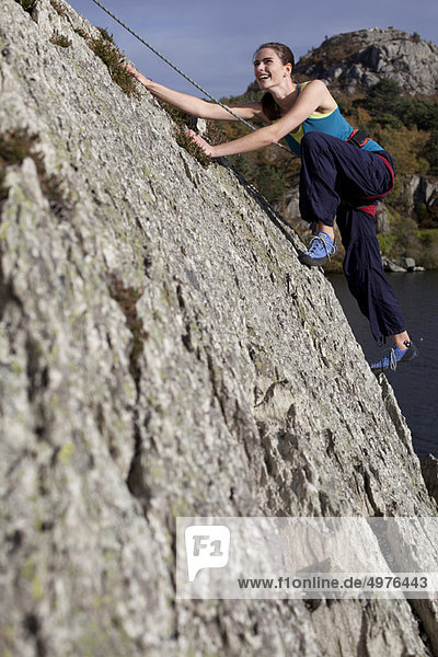 woman climbing a rockface