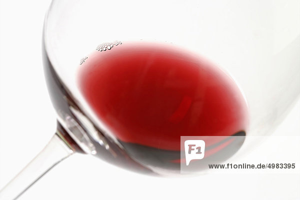 A drop of red wine in a glass