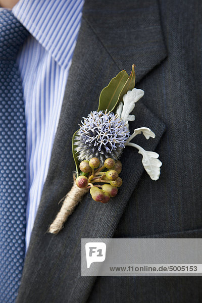 Detail of a corsage on the lapel of a man