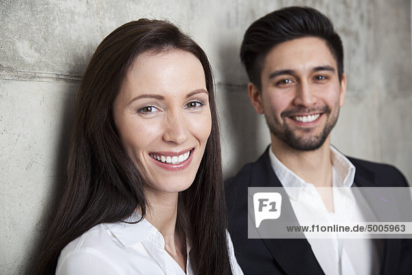 Portrait of a businesswoman and businessman  head and shoulders  focus on woman