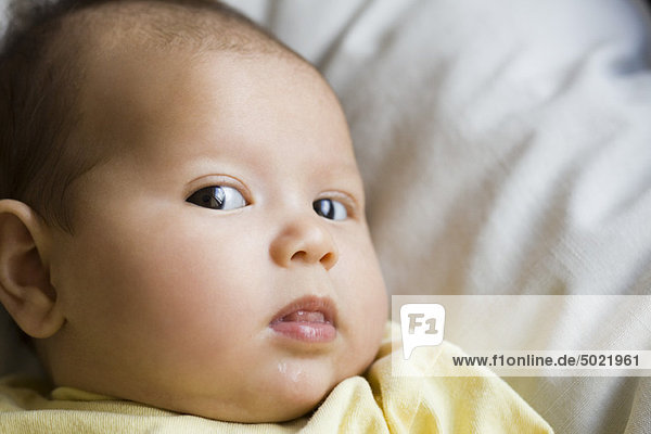 Baby glancing sideways at camera  portrait