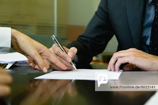 Executive signing paperwork