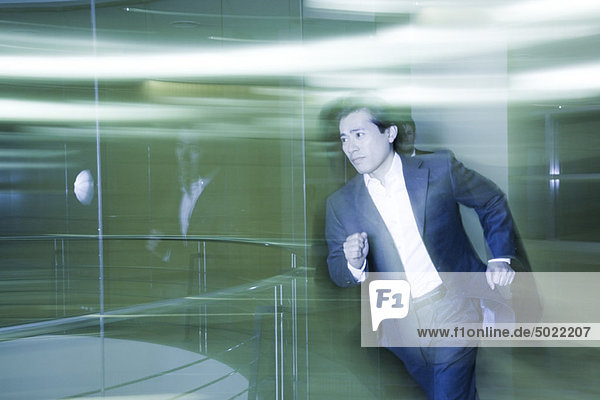 Businessman running in lobby