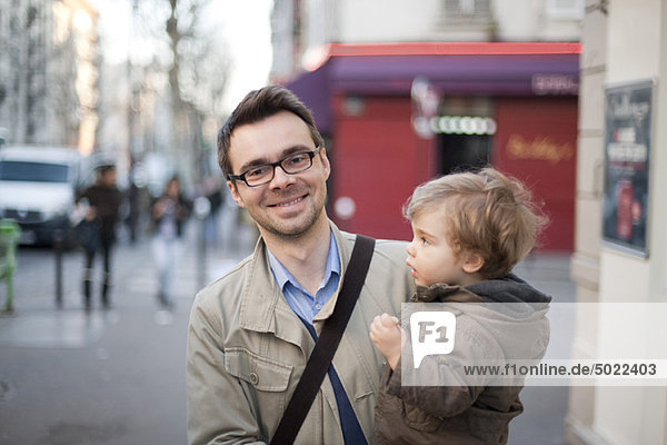 Man carrying toddler son  portrait
