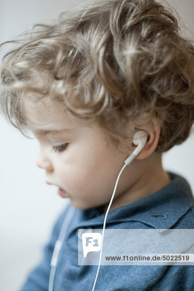 Toddler boy wearing earphones  profile