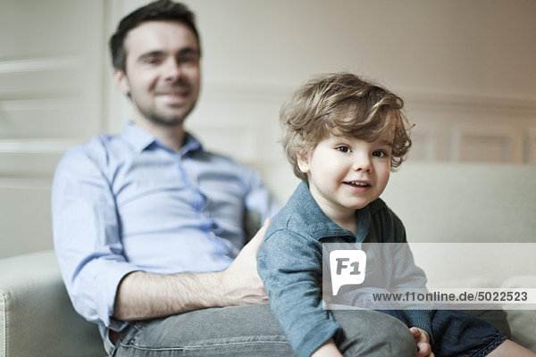 Kleinkind Junge und Vater auf der Couch sitzend