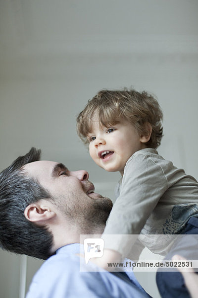 Father holding up young son  portrait