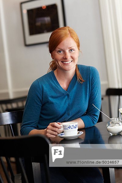 Portrait of young smiling Woman in cafe
